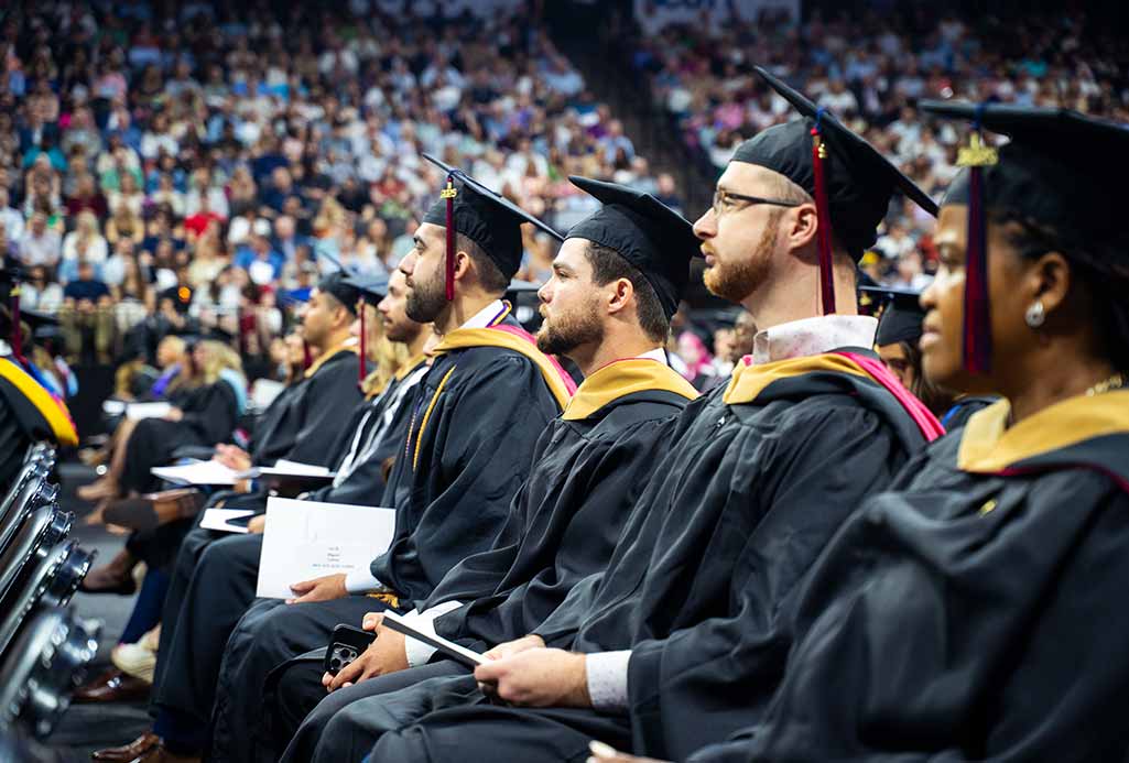 students sitting at commencement ceremony