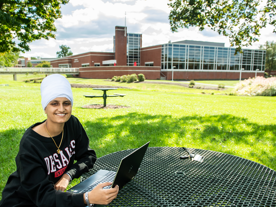 student using a computer outside