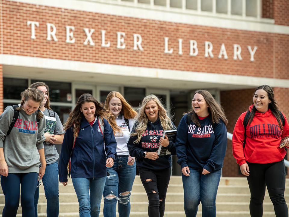 students in front of the library