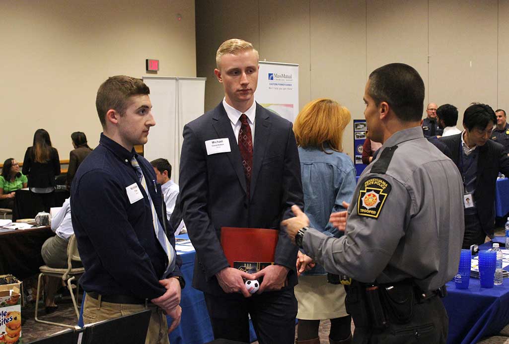 students talking with police officer