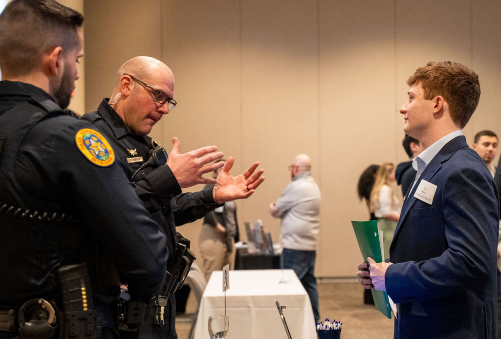 students networking with an alumni