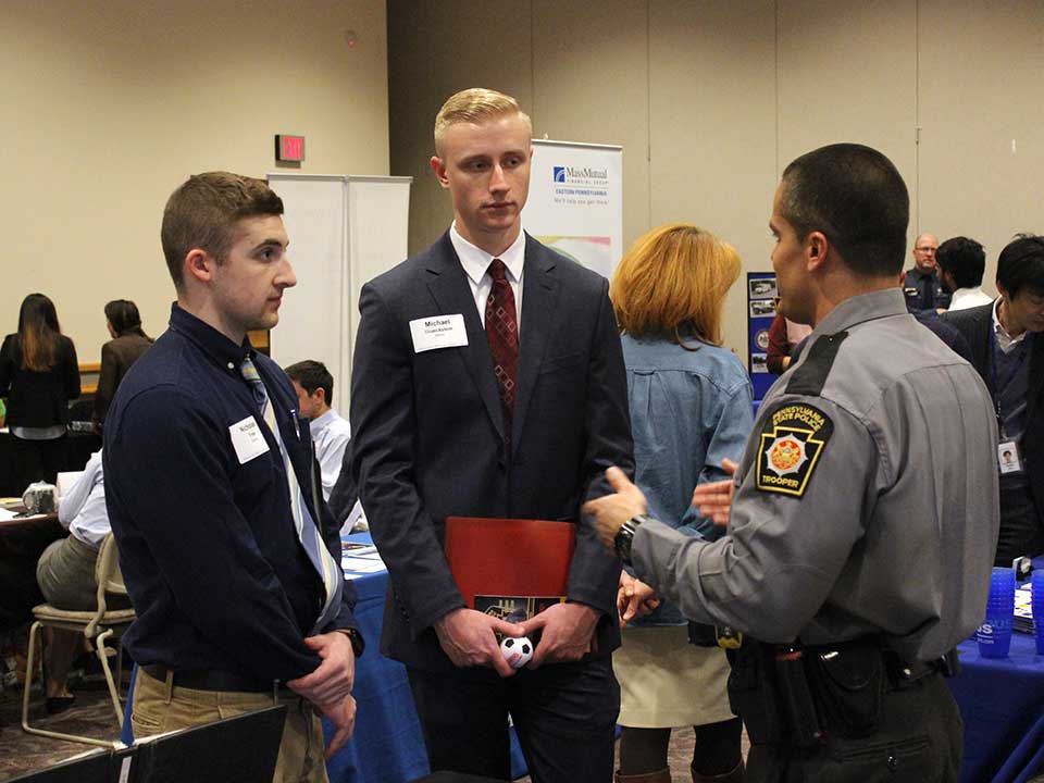 students speaking with police officer