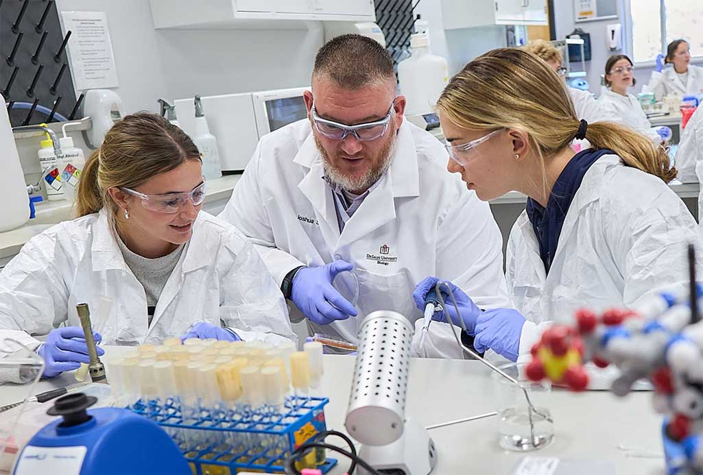 chemistry professor with students in lab