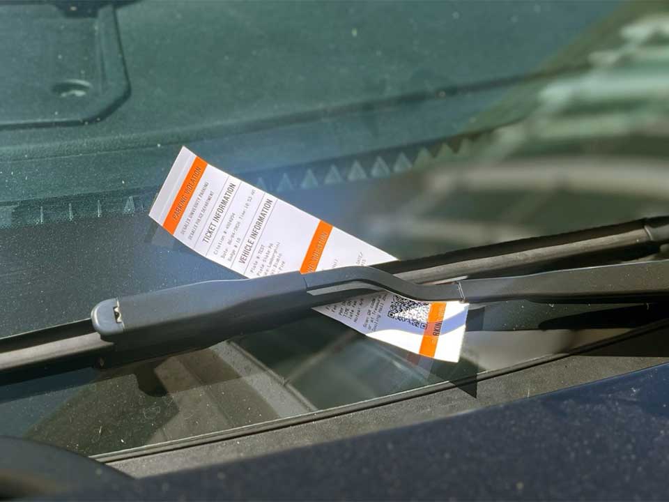 parking ticket on car windshield