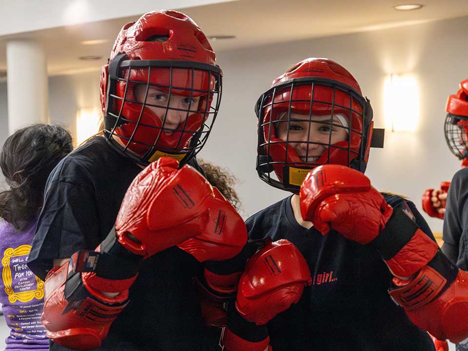 two women posing in self-defense class