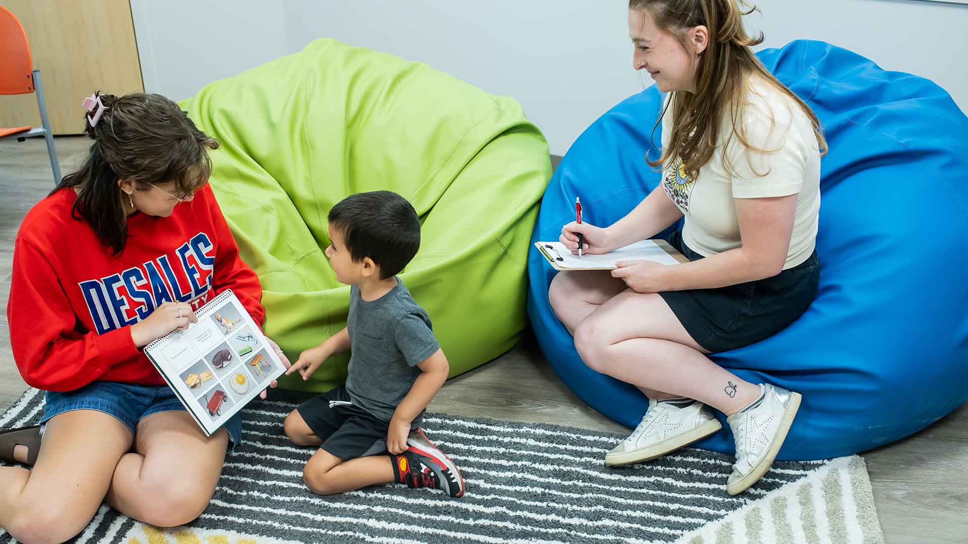 student working with child in speech clinic