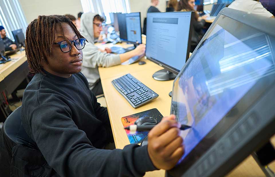 student writing on computer screen for digital art class