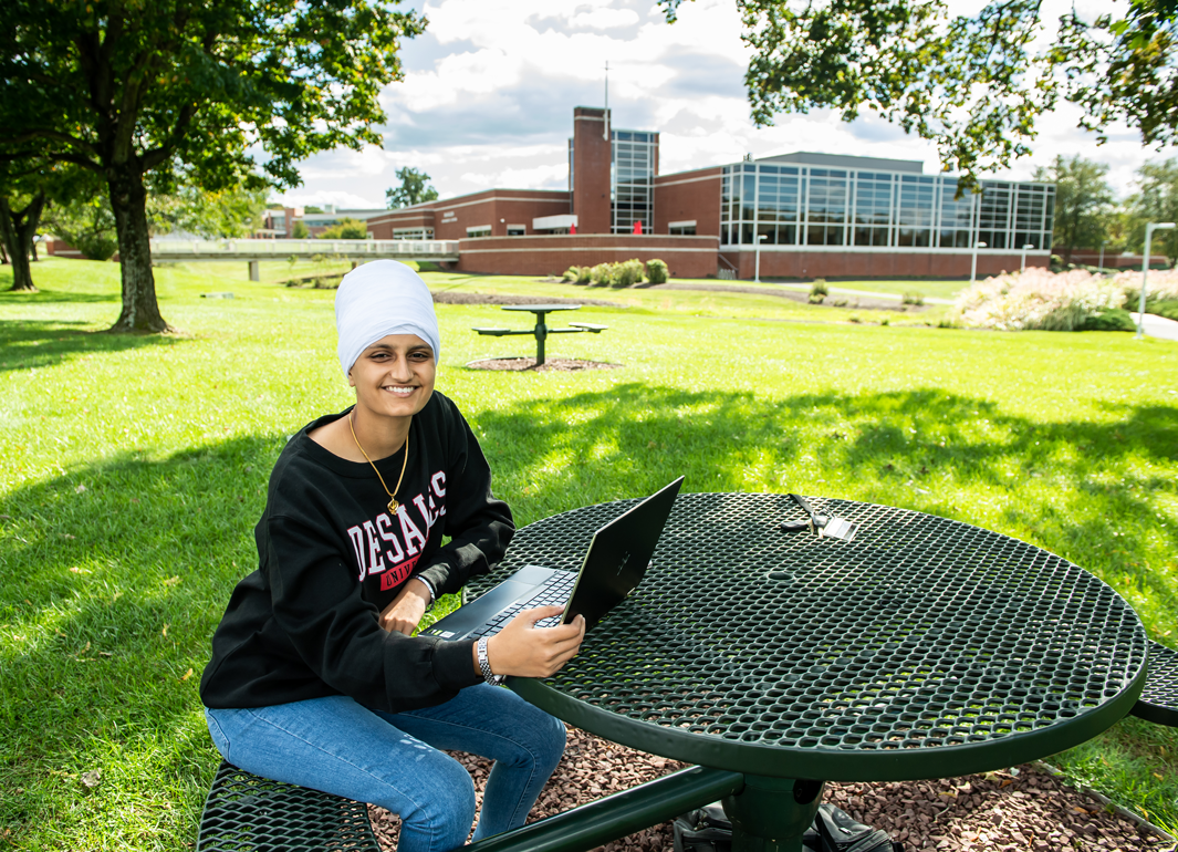 student using laptop outdoors