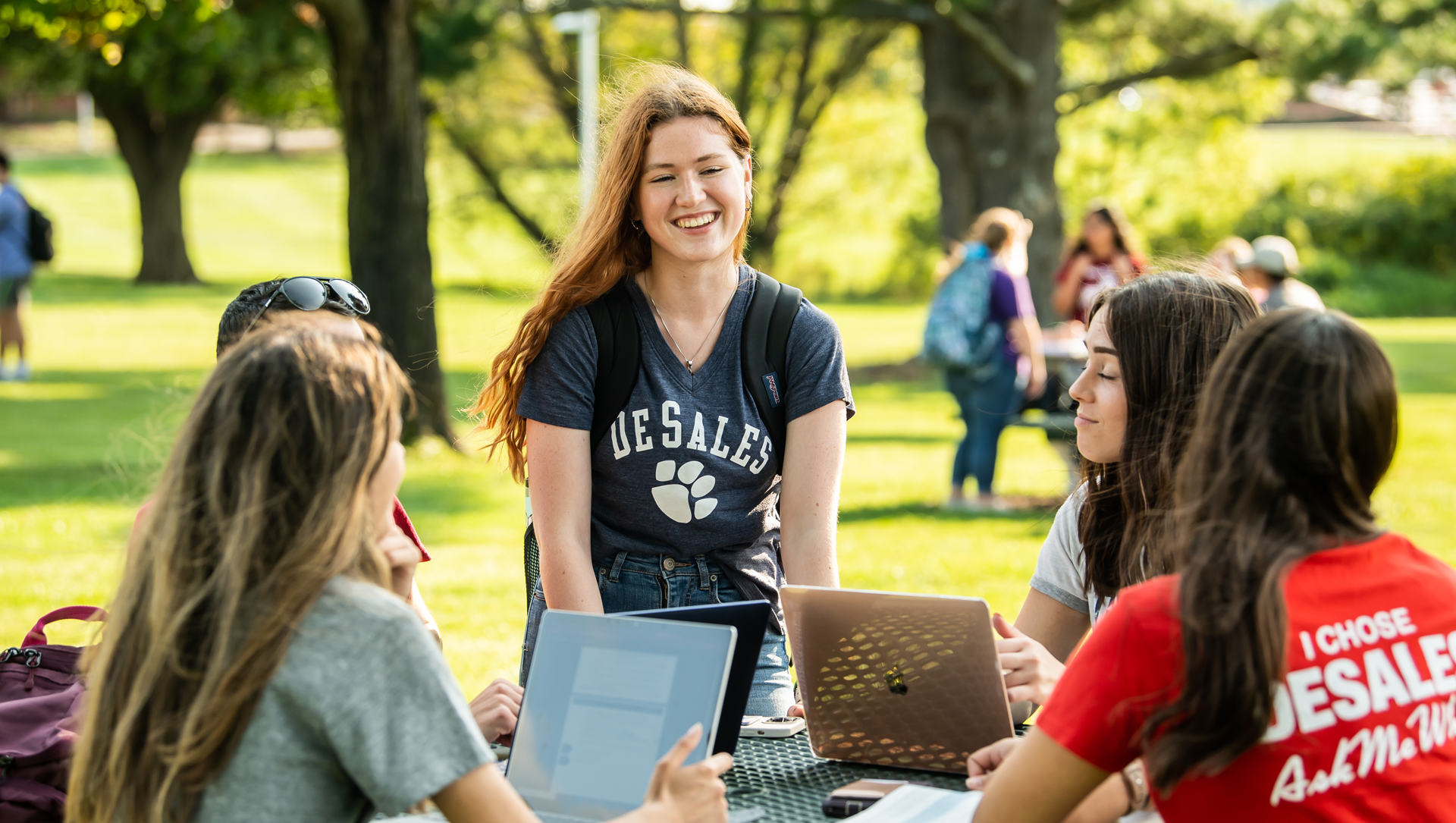 students sitting outside