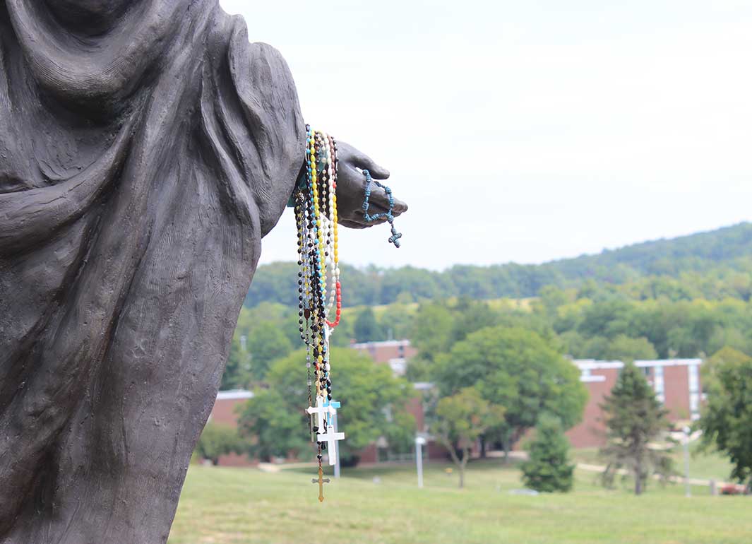 statue holding rosary beads