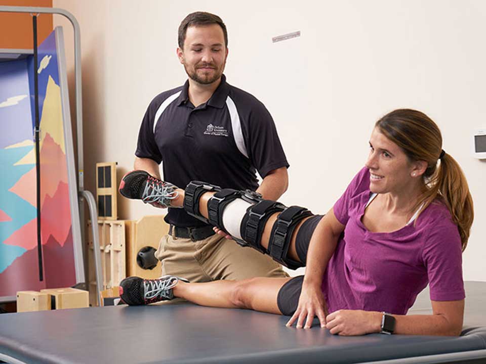 student performing physical therapy on another student