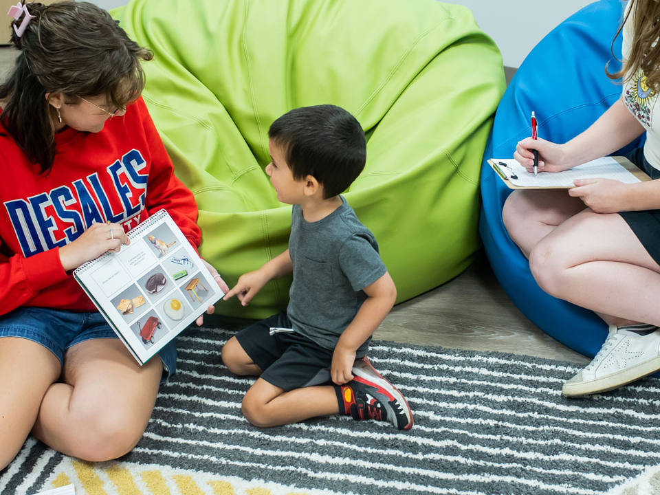 girl showing child a book