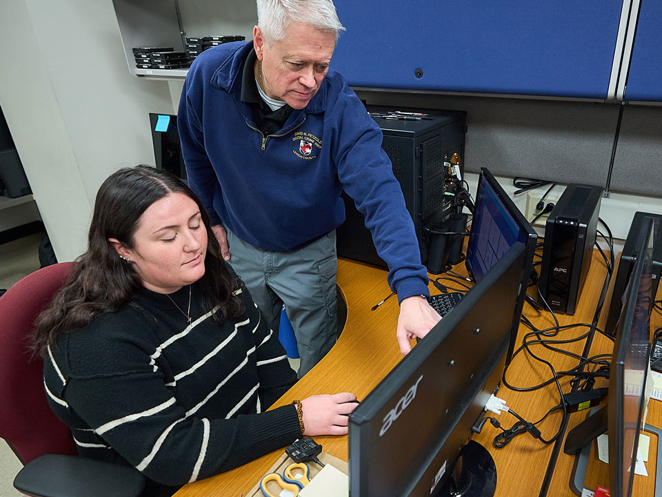 student and professor at computers