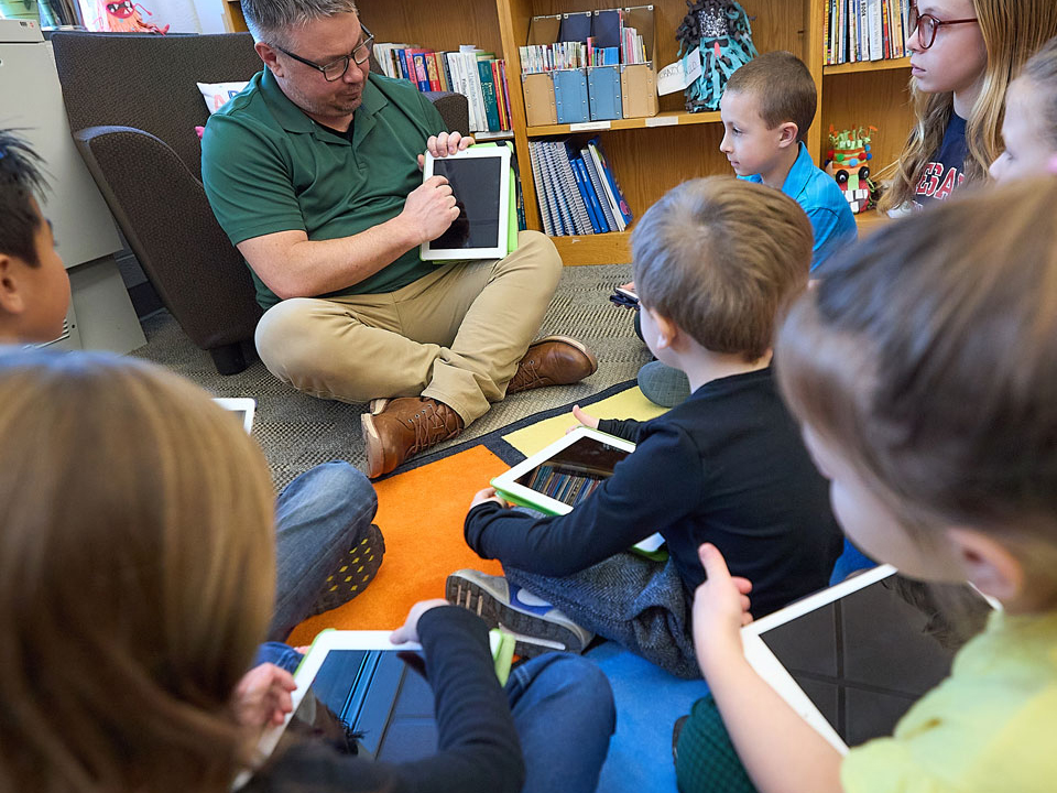 elementary school teacher reading to class