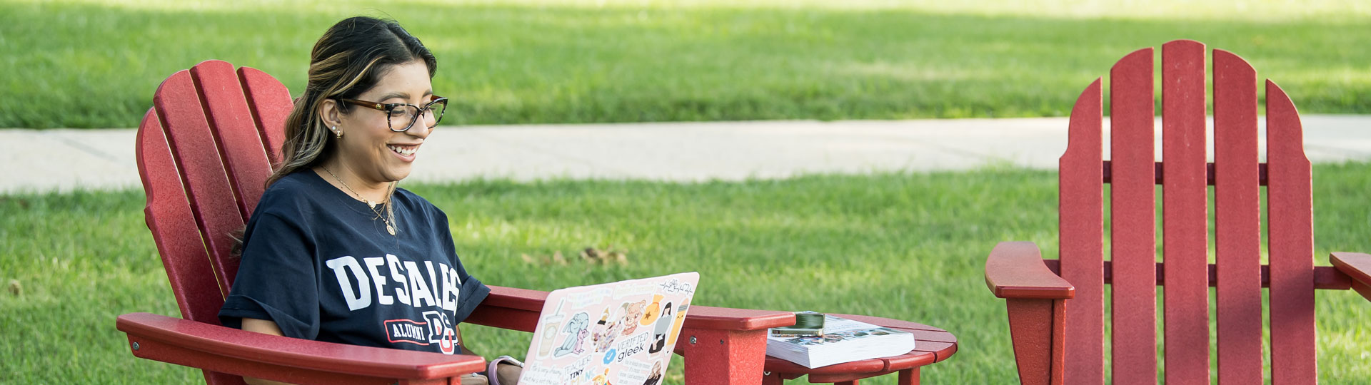 Girl sitting on a chair working on her laptop