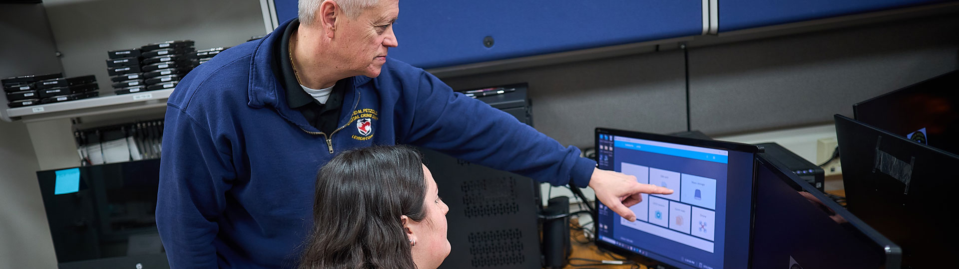 Teacher helping a student using the computer