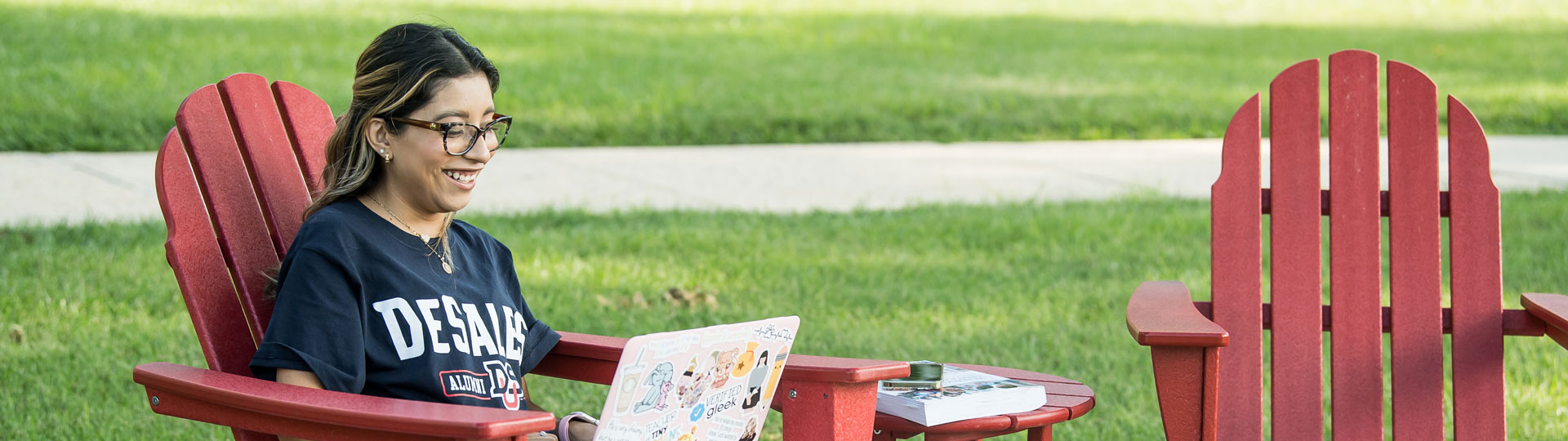 student on laptop outdoors