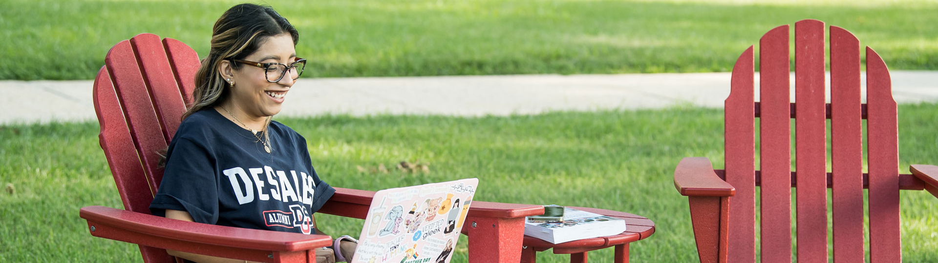 Girl outside working on her laptop