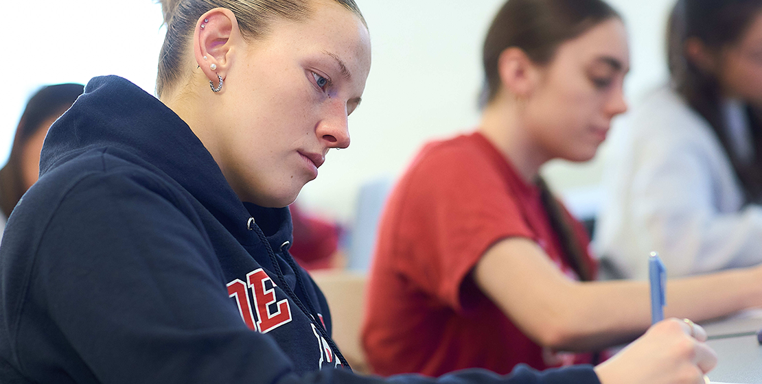 girl taking notes in class