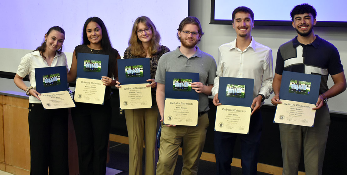group of students holding completion certificates