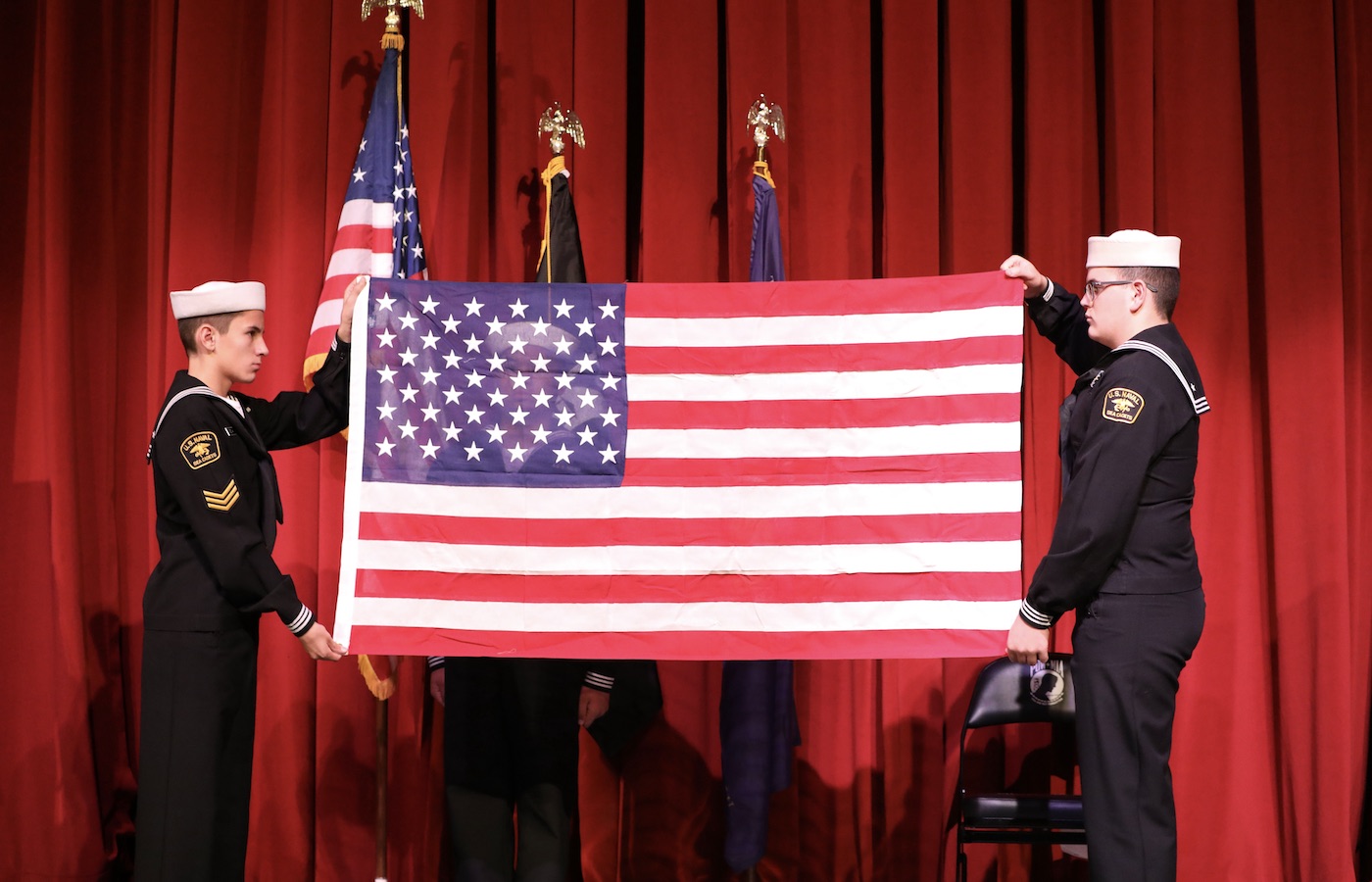 Veterans holding an American flag