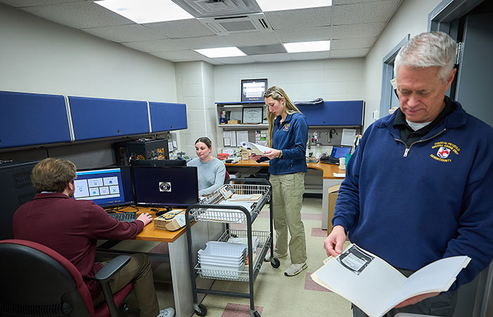 students and professor in digital forensics lab