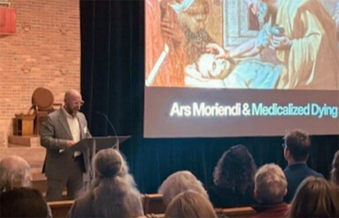 professor lecturing at a podium in a chapel
