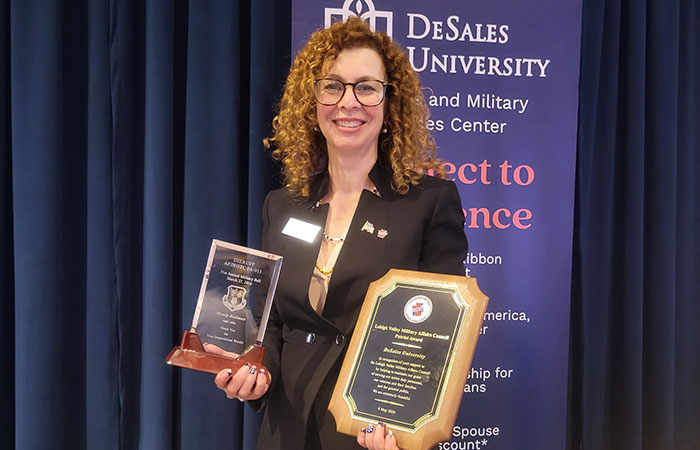 wendy badman posing with award plaques