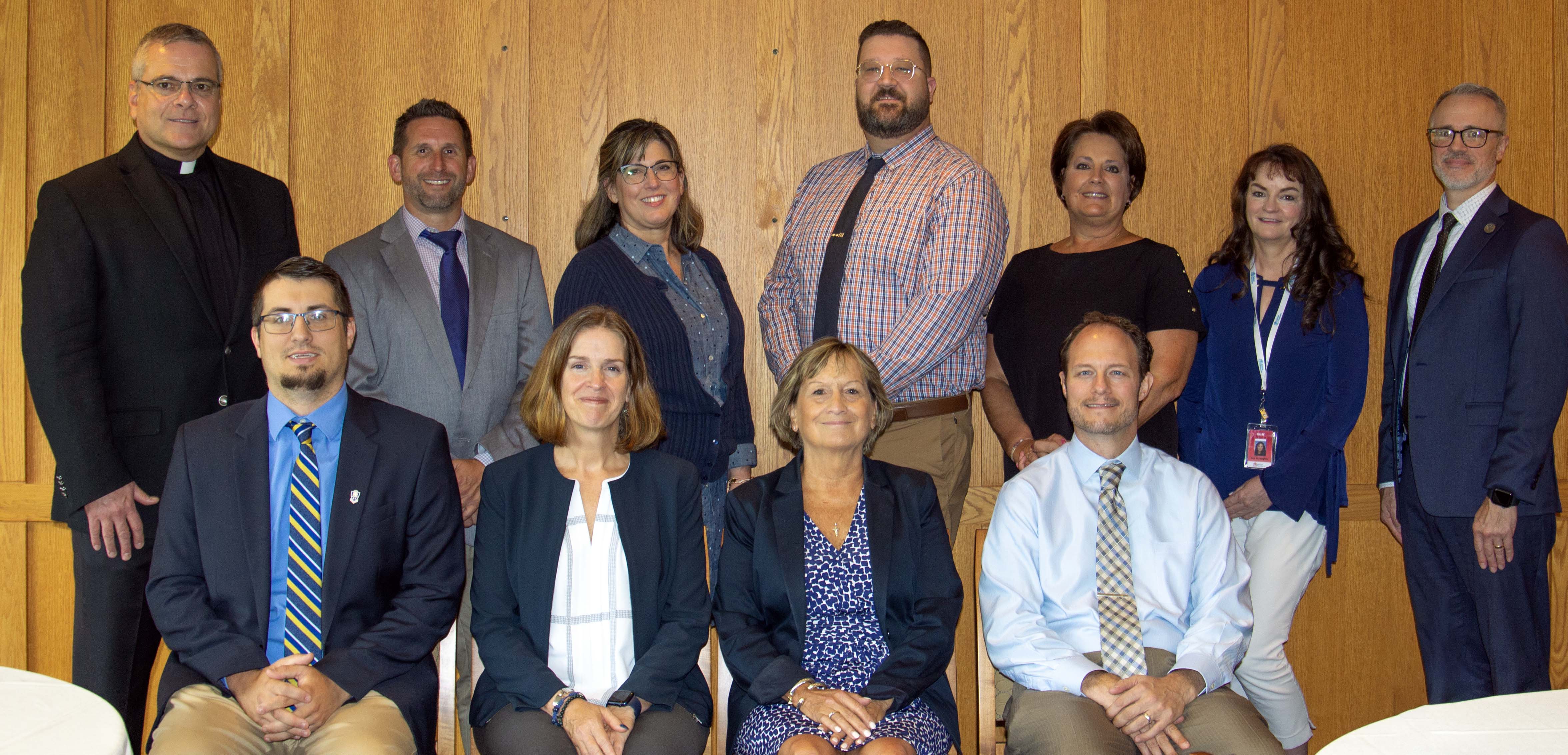 Desales faculty with the four high school representatives