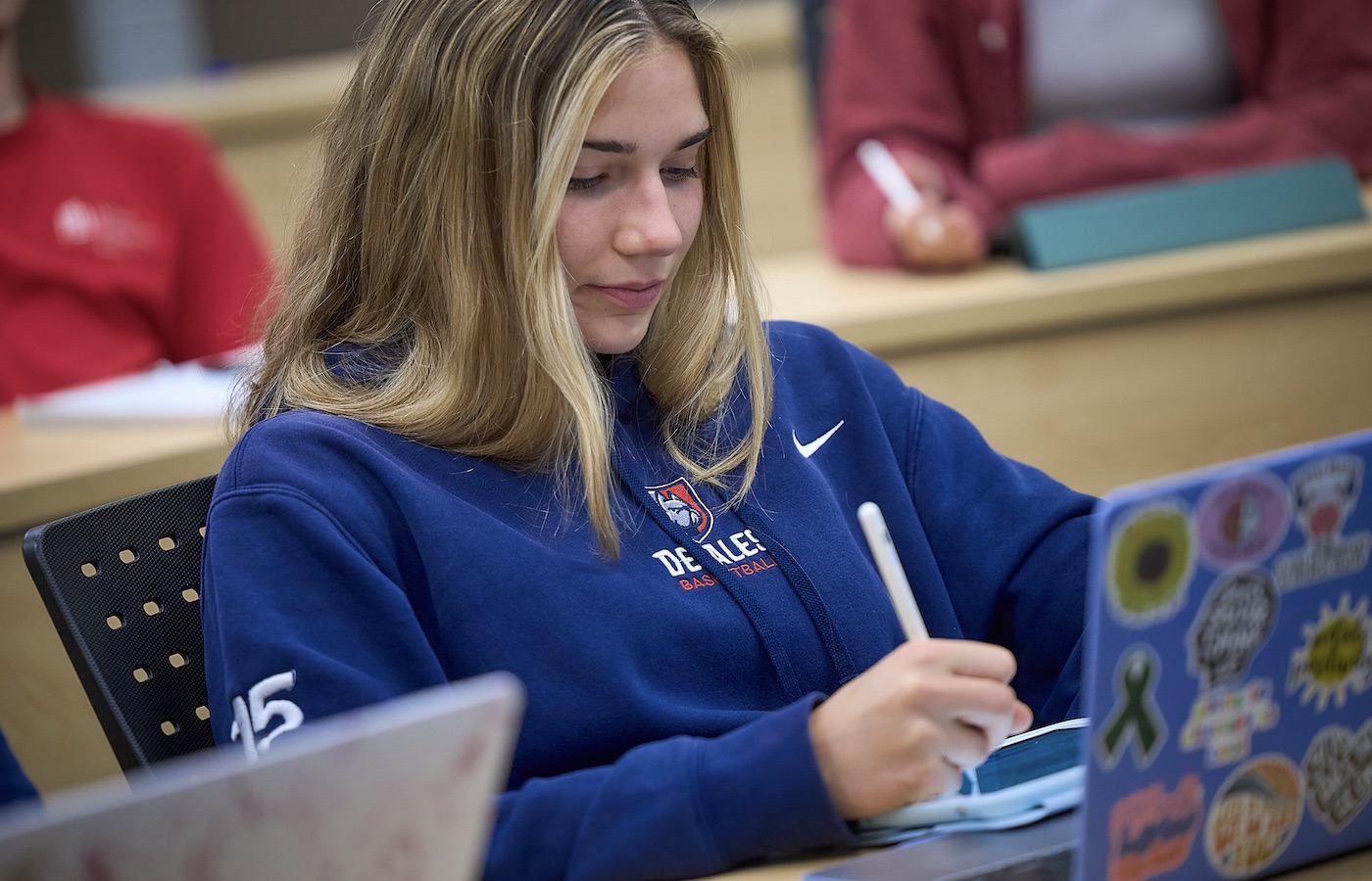 girl taking notes on her tablet